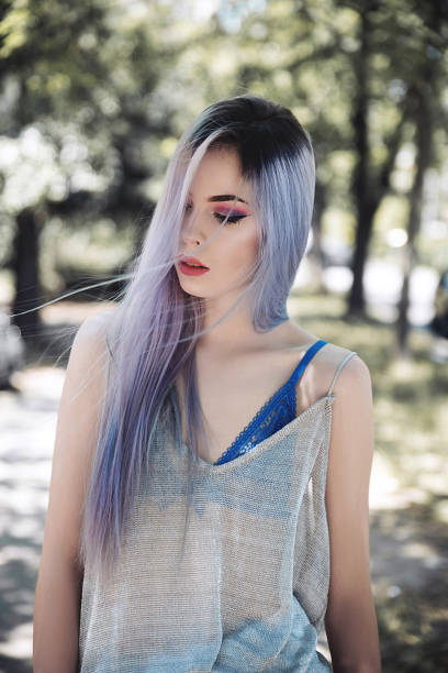 istock Young woman walking in park 923859078