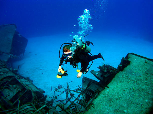 istock Diver photographing a Sunken Shipwreck 92386096