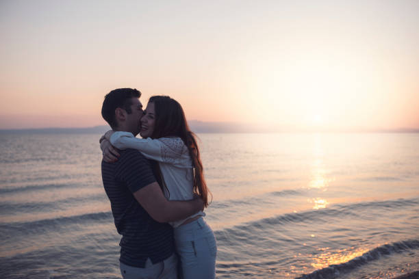 istock Love Couple Smiling and Embracing by Sea 923861666