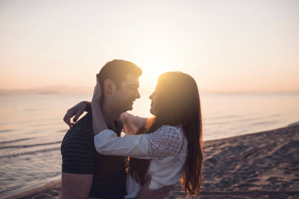istock Love Couple Smiling and Embracing by Sea 923862066