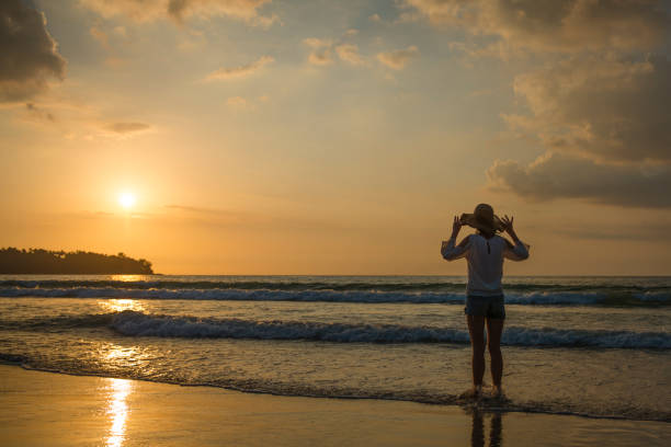 istock Woman standing in Sunset Beach 923862120
