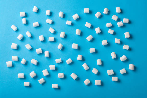 istock Sweet Marshmallows on blue background with a shadow. Flat lay top view 923862178