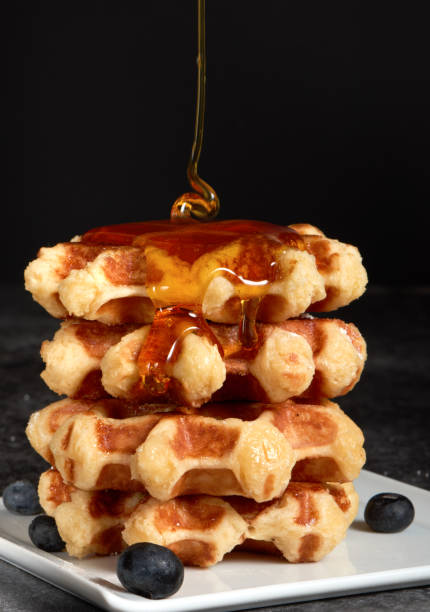 istock Waffles omemade with berries.Side view. Motion food. 923865424