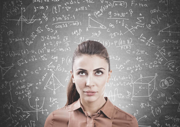 istock Pensive woman in brown, formulas on blackboard 923869352