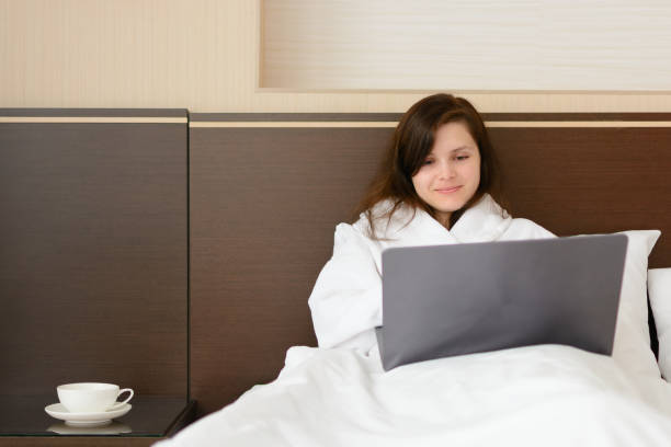 istock Woman with laptop in bed 923875292