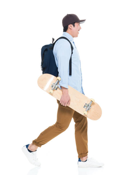 istock Happy Korean Male Student Walking With Skateboard 923875982