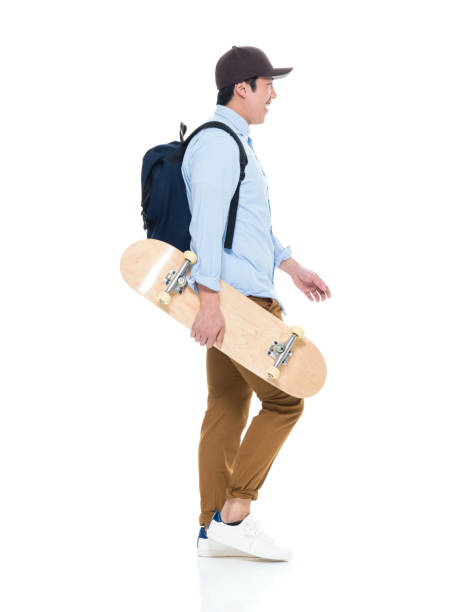 istock Happy Korean Male Student Walking With Skateboard 923876082