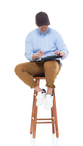 istock Handsome Korean male sitting on stool 923876088