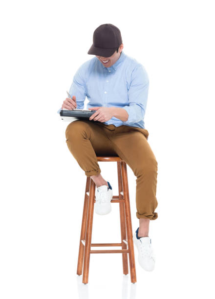 istock Handsome Korean male sitting on stool 923876094