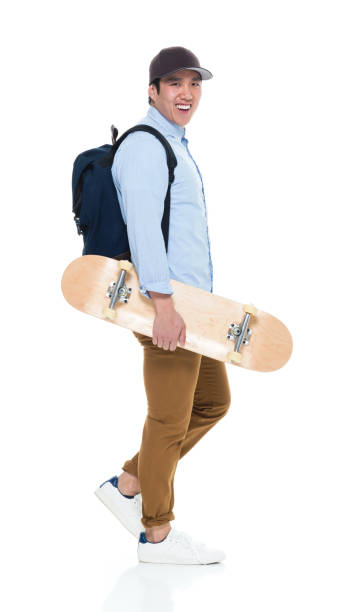 istock Happy Korean Male Student Walking With Skateboard 923876170
