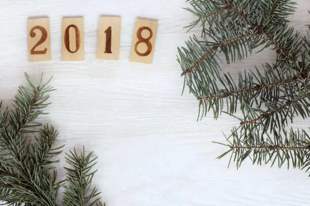Flat layout with green twigs Christmas trees and wooden numbers