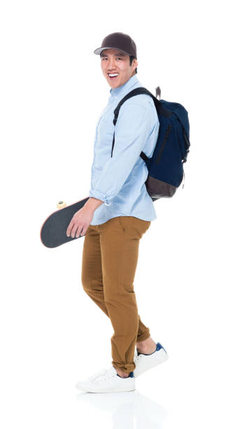 istock Happy Korean Male Student Walking With Skateboard 923876248