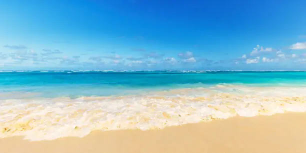 Panoramic photo of a wave on the beach of Arena Gorda Beach, Dominican Republic.
