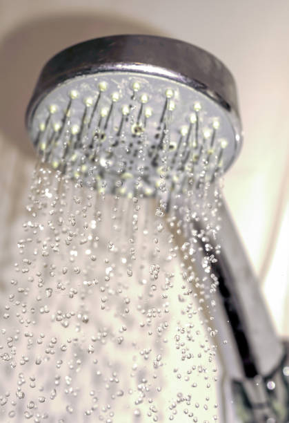istock Water drops close-up dripping from the shower warm filtered 923888624
