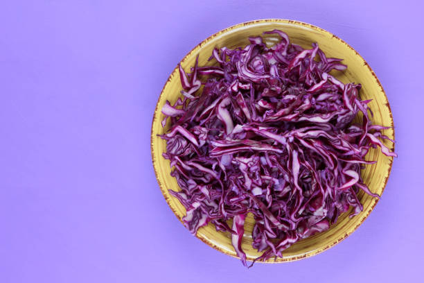 istock Purple cabbage on a yellow plate, cabbage on a purple background, minimalism, vegetables for vegan, sliced cabbage pop art, fresh vegetables on salad, packaging design, art 923891856