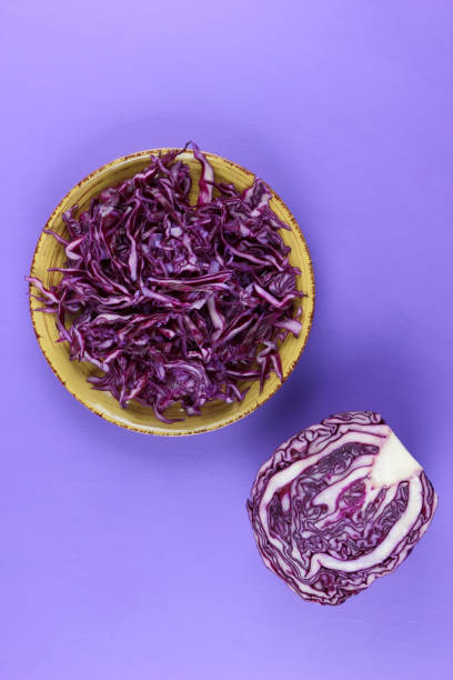istock Purple cabbage on a yellow plate, cabbage on a purple background, minimalism, vegetables for vegan, sliced cabbage pop art, fresh vegetables on salad, packaging design, art 923894096