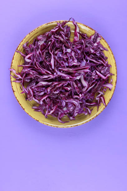 istock Purple cabbage on a yellow plate, cabbage on a purple background, minimalism, vegetables for vegan, sliced cabbage pop art, fresh vegetables on salad, packaging design, art 923894196