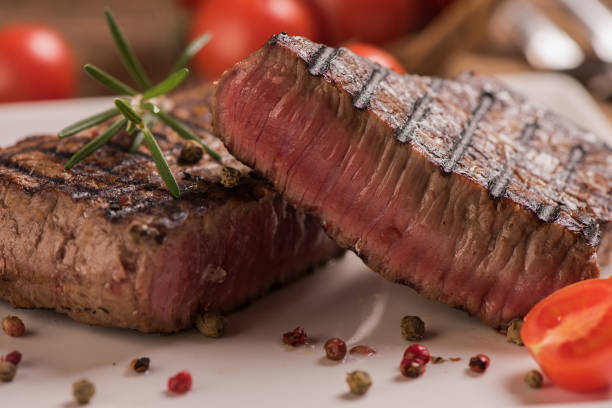 istock Delicious beef steak on wooden table, close-up 923898024