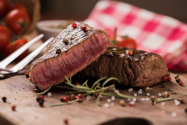istock Delicious beef steak on wooden table, close-up 923898220