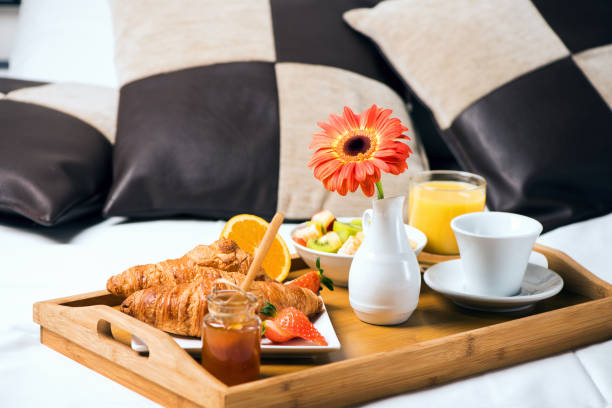istock Tray with breakfast food on the bed inside a bedroom 923898612