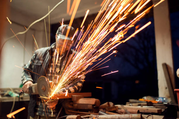 istock Hot sparkles around workshop grinder craftsman sawing. 923898844
