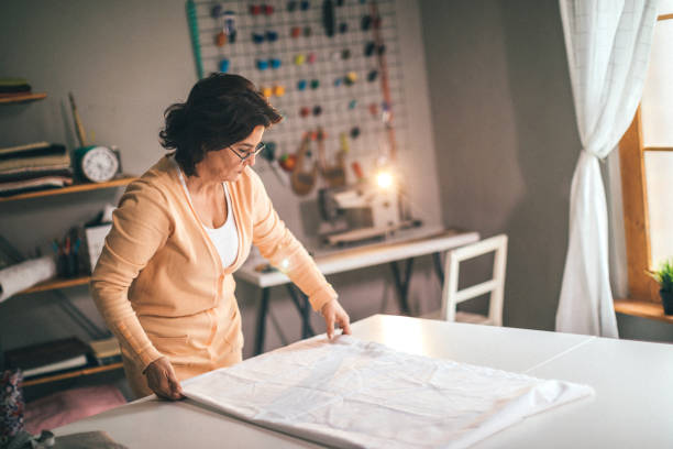 istock Mid adult woman working on cloth part 923901844