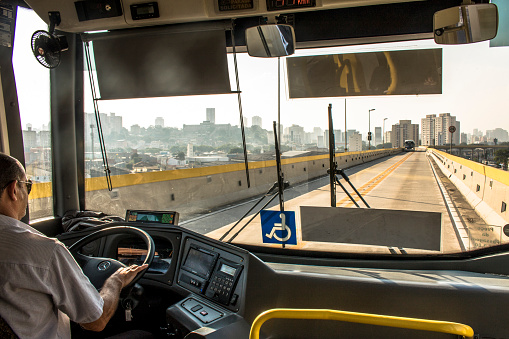 Sao Paulo, SP, Brazil, December 14, 2017. Bus driver drives an articulated bus that travels on the Tiradentes Express, formerly Fura-fila, on the east side of Sao Paulo