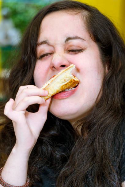 istock Young woman eating pizza 923913450