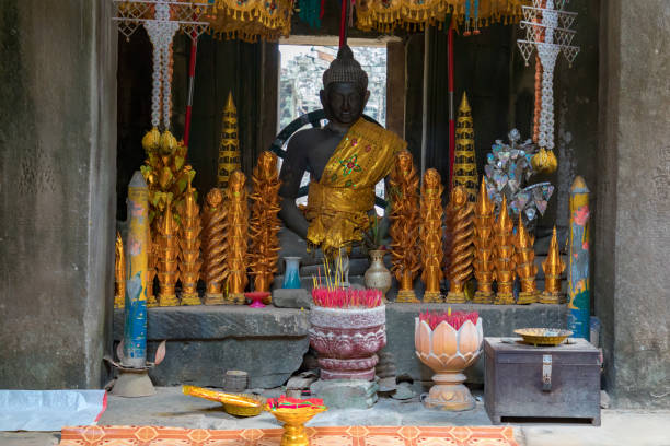 Beautiful Buddha Statue inside the ancient temple area  of Banteay Kdei, South-East of the Ta Prohm Temple in the Angkor Wat Temple Area. Banteay Kdei, Angkor Wat, Siem Reap, Cambodia.