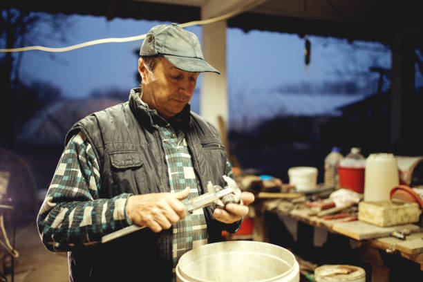 istock Middle aged man at workshop late night working hard. 923916260