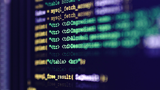 Close up of a program code on a computer screen. Technology, coding, programming, it, software development and hacking concept.