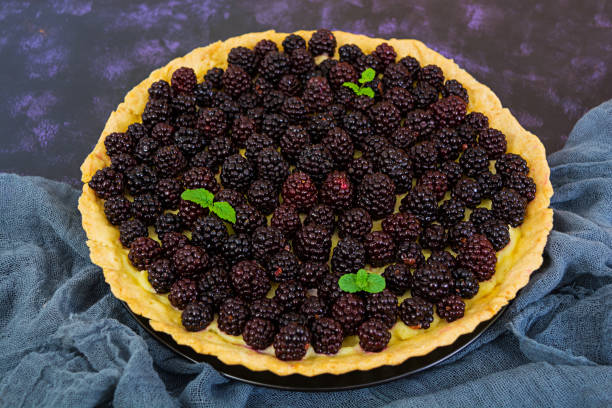 istock Delicious tart with blackberries on dark background 923933214