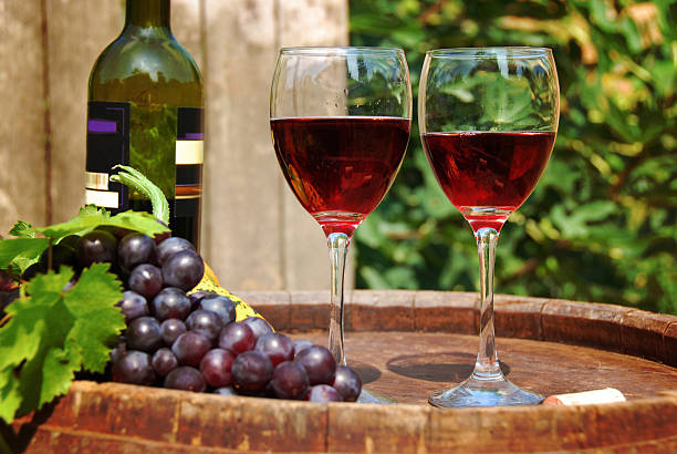 istock Glass of red wine with bottle and fresh grapes 92394321