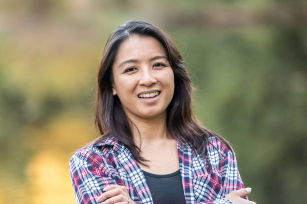 Smiling mid adult asian woman Smiling mid adult asian woman looking at the camera cambodian ethnicity stock pictures, royalty-free photos & images