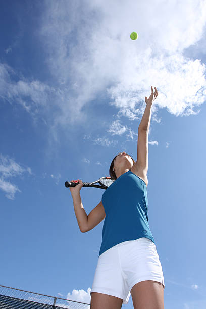 istock Female Tennis Player Serving with a Cloudy Sky 92395246