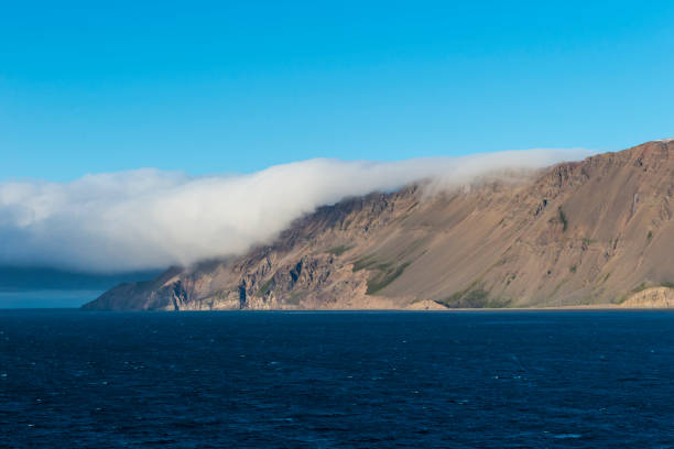 Iceland is an island country at the confluence of the North Atlantic and Arctic Oceans, east of Greenland and immediately south of the Arctic Circle