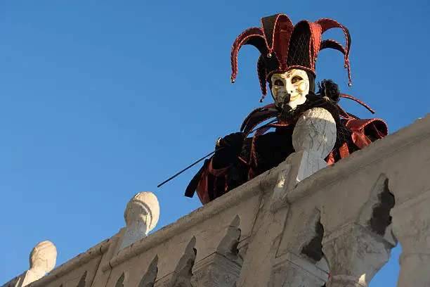 Male mask in creative jester costume on a bridge at the carnival 2008 in Venice, Italy.