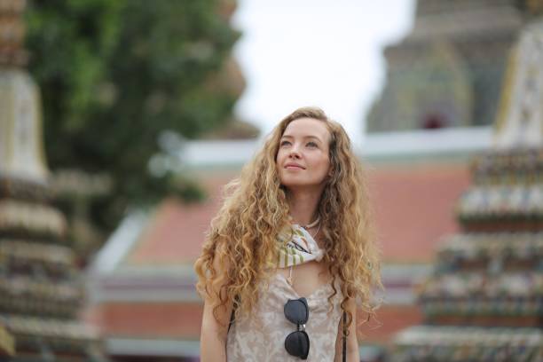 istock Young tourist woman visiting temple 923955732