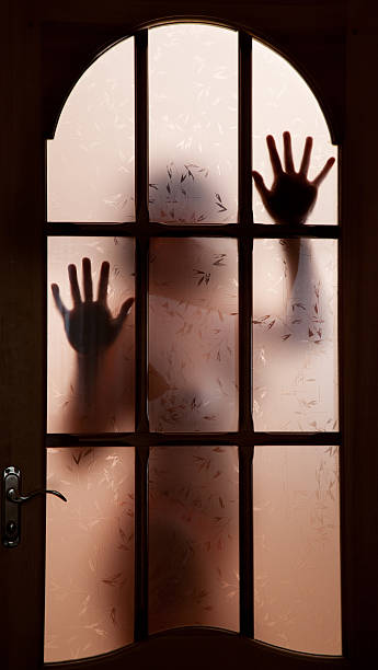 istock Woman silhouette behind the door 92396296