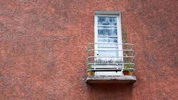 old balcony with flowers on the wall stock photo