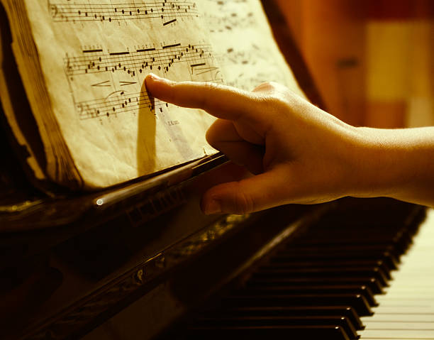istock child finger at music sheet 92396663