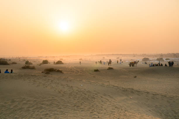 istock Foggy sunset in thar desert with camels on horizon 923977376