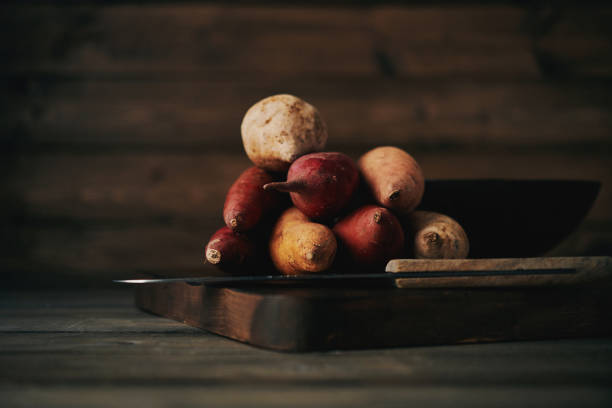 istock Still life of assorted potatoes shot in dark moody light 923977476