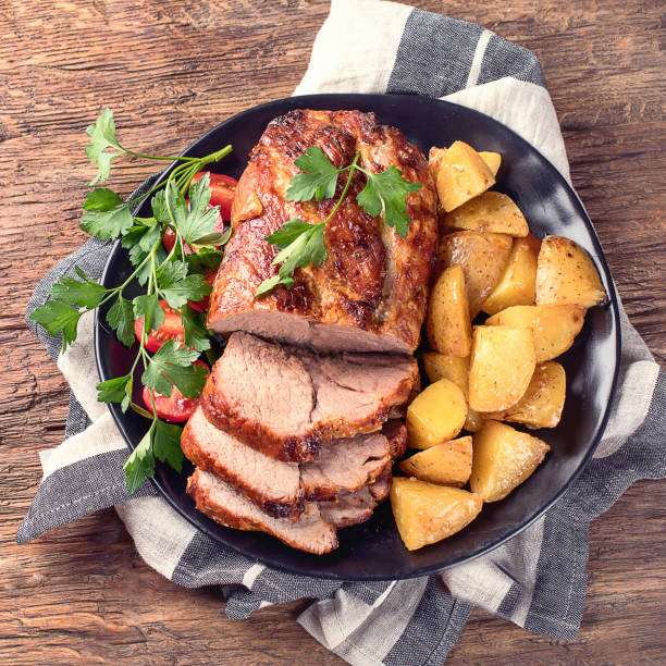 istock Roast pork with herbs and vegetables 923988982