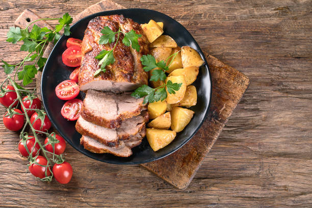 istock Roast pork with herbs and vegetables 923989052