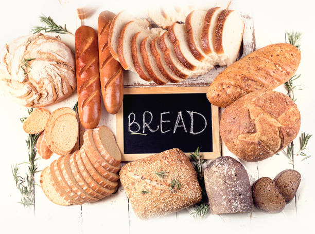 istock Fresh bread on white wooden table 923989060