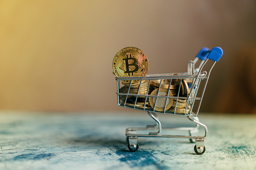 Antalya, Turkey - February 23, 2018:Golden bitcoin on the Shopping cart