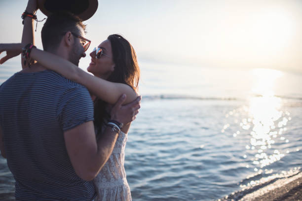 istock Love Couple Smiling and Embracing by Sea 923997502