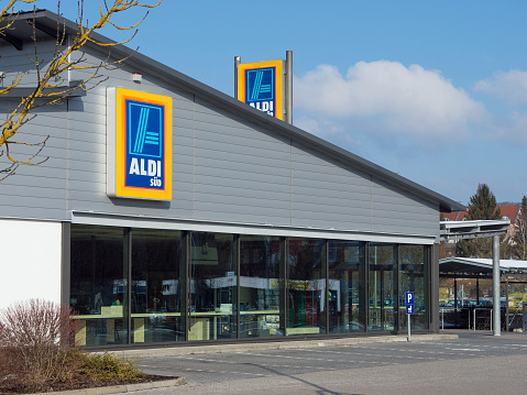 Amberg, Germany - February 18, 2018: ALDI store in Amberg, Bavaria, Germany, Europe. ALDI is a german discount market chain with headquarter in Mühlheim an der Ruhr, Germany. Logo of ALDI SÜD on the facade. Sunday morning - no people in the store.