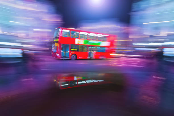 Big Ben at sunset with a London bus on Westminster Bridge.